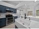 Modern kitchen boasts stainless appliances, quartz countertops and a farmhouse sink at 9885 Se 144Th St, Summerfield, FL 34491