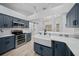 This modern kitchen boasts stainless appliances, quartz countertops, and shaker cabinets at 9885 Se 144Th St, Summerfield, FL 34491