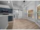 Eat in kitchen with modern light fixture and view of the barn door entry to a bedroom or bathroom at 9885 Se 144Th St, Summerfield, FL 34491