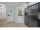 Kitchen area with a pantry and laundry room, plus a stainless steel refrigerator at 9885 Se 144Th St, Summerfield, FL 34491