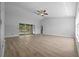 Bright living room with wood-look flooring and sliding glass doors to the backyard at 9885 Se 144Th St, Summerfield, FL 34491