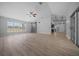 Open-concept living room with wood-look floors, lots of natural light, and access to the backyard at 9885 Se 144Th St, Summerfield, FL 34491