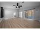 Bright main bedroom features an overhead fan and sliding glass doors leading to the lanai at 9885 Se 144Th St, Summerfield, FL 34491