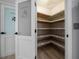 Walk-in pantry featuring lots of shelving for optimized food and supply storage at 9885 Se 144Th St, Summerfield, FL 34491