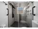 Modern shower stall with multiple shower heads, safety grab bars, and corner shelves at 9885 Se 144Th St, Summerfield, FL 34491