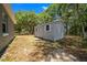 Exterior shot of storage building on a wooded lot with leaves at 9885 Se 144Th St, Summerfield, FL 34491