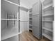 Spacious walk-in closet with custom shelving and ample storage space for organization at 9885 Se 144Th St, Summerfield, FL 34491
