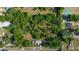 Aerial view showcasing the property's extensive land, surrounding trees, and overall location at 1039 Ne 25Th St, Ocala, FL 34470