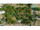 Aerial view of a large property outlined in red, showcasing mature trees, the home, and surrounding neighborhood at 1039 Ne 25Th St, Ocala, FL 34470