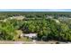 Aerial view showcases the home's location surrounded by mature trees in a serene neighborhood at 1039 Ne 25Th St, Ocala, FL 34470