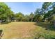 Spacious backyard with lush green grass and mature trees, offering ample space for outdoor activities at 1039 Ne 25Th St, Ocala, FL 34470