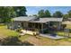 The backyard features a wooden deck, a screened-in porch, and gravel landscaping for outdoor enjoyment at 1039 Ne 25Th St, Ocala, FL 34470
