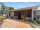 A backyard featuring a wooden deck and screened-in porch offers a relaxing outdoor living space at 1039 Ne 25Th St, Ocala, FL 34470