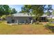 Backyard view featuring landscaping, patio and screened in porch to enhance outdoor living at 1039 Ne 25Th St, Ocala, FL 34470
