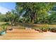 Expansive backyard with lush greenery, viewed from the wooden deck, creates an inviting outdoor space at 1039 Ne 25Th St, Ocala, FL 34470