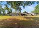 The backyard of the house includes a wooden deck and screened in porch to enhance outdoor living at 1039 Ne 25Th St, Ocala, FL 34470