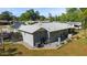 Backyard view featuring gravel landscaping, patio and screened in porch to enhance outdoor living at 1039 Ne 25Th St, Ocala, FL 34470