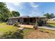 Charming home featuring a lovely wooden patio deck, perfect for outdoor relaxation and gardening at 1039 Ne 25Th St, Ocala, FL 34470