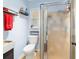 Bathroom features shower, toilet, small window, and mounted shelves at 1039 Ne 25Th St, Ocala, FL 34470