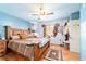 Rustic bedroom with blue wood paneling, ceiling fan, and unique Southwestern-style decor at 1039 Ne 25Th St, Ocala, FL 34470