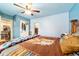 Comfortable bedroom boasts blue paneled walls, ceiling fan and Southwestern inspired decor at 1039 Ne 25Th St, Ocala, FL 34470