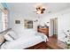 Cozy bedroom features a paneled wall, ceiling fan, and natural light from a window at 1039 Ne 25Th St, Ocala, FL 34470