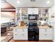 Bright kitchen features granite counters, white cabinetry, open shelving, and stainless steel appliances at 1039 Ne 25Th St, Ocala, FL 34470
