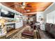 Comfortable living room featuring hardwood floors, built-in shelving, a fireplace, and exposed wood beams at 1039 Ne 25Th St, Ocala, FL 34470