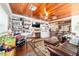 Inviting living room with a wood-paneled ceiling, built-in shelving, and a cozy fireplace at 1039 Ne 25Th St, Ocala, FL 34470