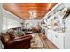Inviting living room featuring wood ceiling, cozy seating, built-in shelving, and a fireplace, perfect for relaxation at 1039 Ne 25Th St, Ocala, FL 34470