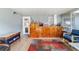 Enclosed porch with wooden bar and bright indoor/outdoor rug creates a fun and functional space at 1039 Ne 25Th St, Ocala, FL 34470