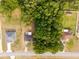 An aerial view of a cozy house nestled among lush, mature trees in quiet neighborhood at 10881 Sw 62Nd Avenue Rd, Ocala, FL 34476