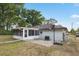 Backyard exterior featuring a screened-in patio and a basketball hoop at 10881 Sw 62Nd Avenue Rd, Ocala, FL 34476