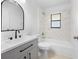 Bathroom with a vanity, toilet, and a marble-tiled shower/tub at 10881 Sw 62Nd Avenue Rd, Ocala, FL 34476