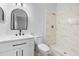 Bathroom with updated vanity, toilet, and a marble-tiled shower at 10881 Sw 62Nd Avenue Rd, Ocala, FL 34476