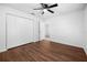 Bedroom with wood floors, ceiling fan, closet, and an exterior door at 10881 Sw 62Nd Avenue Rd, Ocala, FL 34476
