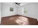 Bedroom features wood floors, ceiling fan, and two windows at 10881 Sw 62Nd Avenue Rd, Ocala, FL 34476