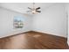 Bright bedroom with ceiling fan, wood floors, and a large window at 10881 Sw 62Nd Avenue Rd, Ocala, FL 34476