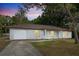 Charming single-story home featuring a manicured lawn and a welcoming facade at dusk at 10881 Sw 62Nd Avenue Rd, Ocala, FL 34476