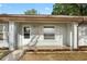 Inviting front porch area with a storm door and white-framed window at 10881 Sw 62Nd Avenue Rd, Ocala, FL 34476