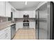 Modern kitchen with stainless steel appliances, granite countertops, and white cabinetry at 10881 Sw 62Nd Avenue Rd, Ocala, FL 34476