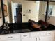 Bathroom with a vessel sink, dark countertop, and white cabinets at 11120 Sw 71St Terrace Rd, Ocala, FL 34481