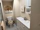 Bright bathroom featuring white cabinets and drawers, a toilet, and wall art at 11120 Sw 71St Terrace Rd, Ocala, FL 34481