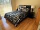Cozy bedroom showcasing a queen bed, wood floors, and sliding glass door at 11120 Sw 71St Terrace Rd, Ocala, FL 34481