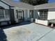 View of the home's front entrance featuring a covered porch and well maintained landscaping at 11120 Sw 71St Terrace Rd, Ocala, FL 34481