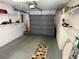 Organized garage featuring shelving, gray door, and gray painted floor at 11120 Sw 71St Terrace Rd, Ocala, FL 34481