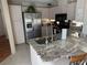 Bright kitchen with granite counters, stainless steel fridge, and a functional island at 11120 Sw 71St Terrace Rd, Ocala, FL 34481