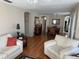 Open-concept living space with hardwood floors seamlessly connecting living and dining areas at 11120 Sw 71St Terrace Rd, Ocala, FL 34481