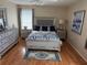 Serene main bedroom featuring hardwood floors, a comfortable bed, and elegant decor at 11120 Sw 71St Terrace Rd, Ocala, FL 34481