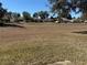 View of large community yard area in a neighborhood of homes under a clear blue sky at 11120 Sw 71St Terrace Rd, Ocala, FL 34481